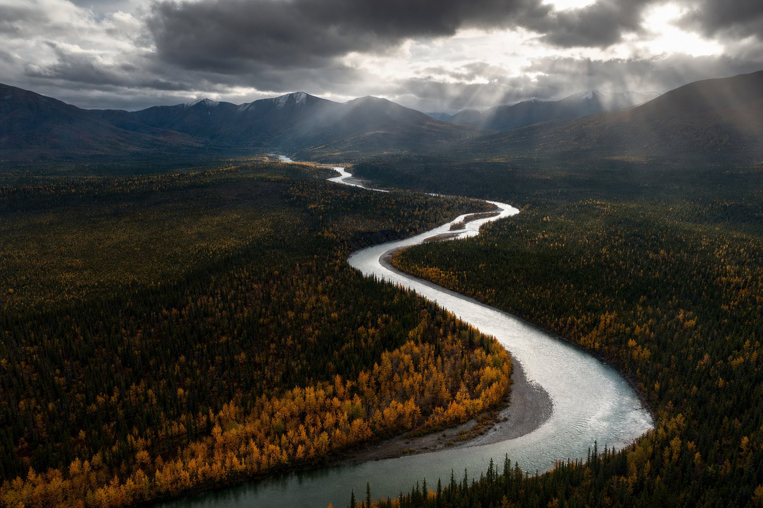 Aerial view of a river meandering through autumn forest, sunbeams breaking through cloud over distant mountains (AI-generated image)
